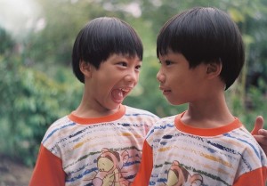 A set of smiling identical twins