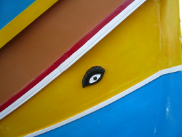 A bright eye painted on a yellow background