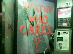 graffiti in telephone kiosk reading 'Apathy who cares?'
