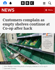 BBC news article "Customers complain as empty shelves continue at Co-op after hack" with a photo of a nearly-epmpty produce section in a supermarket