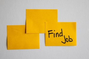 sticky notes on a wall; one reads 'find job'