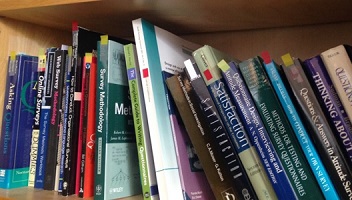 survey books on Caroline's bookshelf