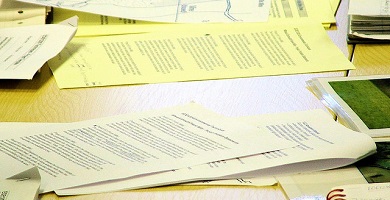 pile of papers on a desk