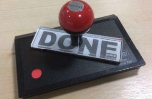 rubber stamp with the word done on it, standing on an ink pad