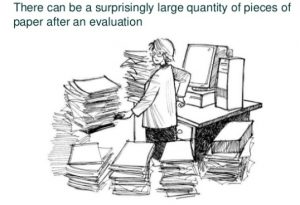 researcher surrounded by huge piles of paper