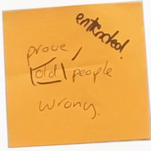 A Post-It note saying "prove old people wrong". Someone has added a note to the word "old" that says "entrenched"
