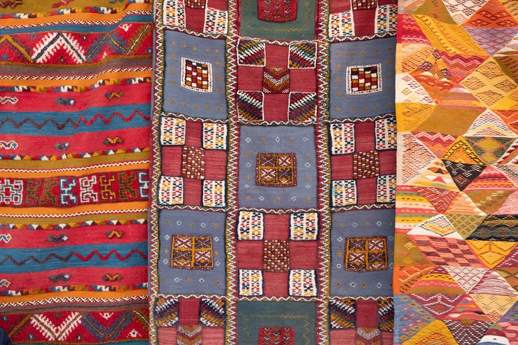 Three patchwork quilts laid side by side