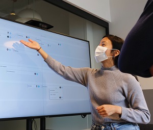 woman presenting alongside a whiteboard