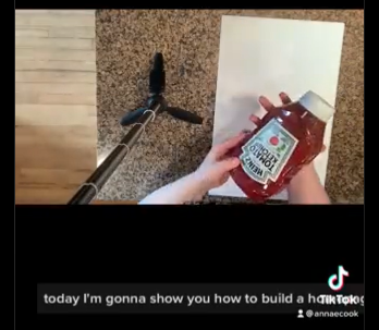 An overhead shot of a big bottle of ketchup that will shortly be squeezed onto a piece of paper