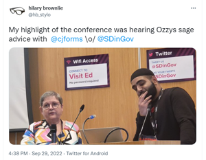 A Tweet from @hbstylo (Hilarie Brownlie) "My highlight of the conference was hearing Ozzys sage advice with @cjforms \o/ @sdingov", with a photograph of Ozzy (tall, bearded, wearing a black Muslim cap) and me (shorter, white, wearing glasses and a brightly patterned dress)