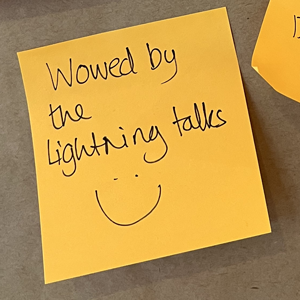 Sticky note saying "Wowed by the lightning talks" with a smiley face doodle