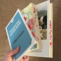 Three books: Presenting design work, The Address Book, and Fieldwork, pictured with lots of sticky index flags sticking out of them